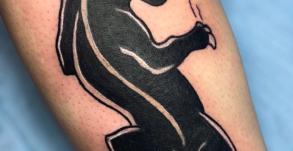 Tatouage panthère old school avec casquette, inspiré du style Peaky Blinders, réalisé par Tamara Chaudesaigues chez Graphicaderme, studio de tatouage à Avignon